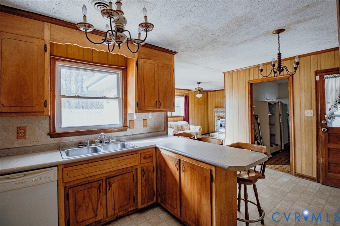 6710 Heritage Road Prince George, VA 23875 - Photo 11 of 27 a kitchen with a sink a center island and a window