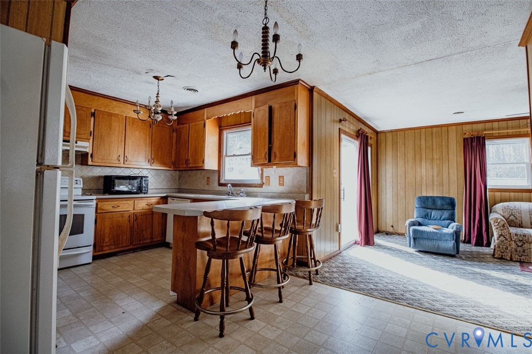 6710 Heritage Road Prince George, VA 23875 - Photo 12 of 27 a kitchen that has a lot of cabinets a sink and a refrigerator