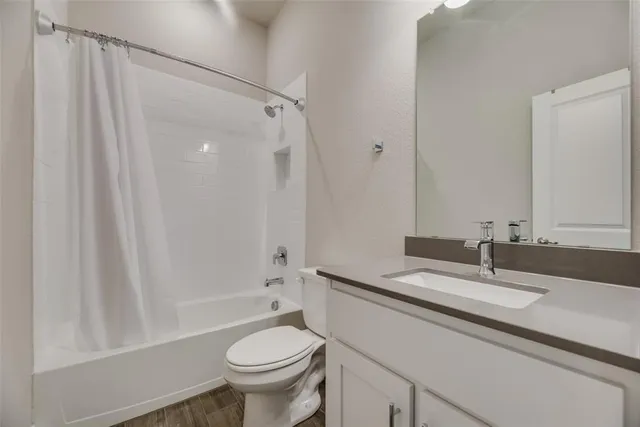 a bedroom with a bed tv and a chandelier