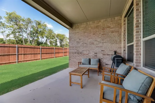 a view of a backyard with a fence