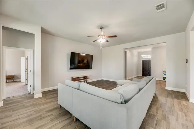 a large kitchen with kitchen island a stove a sink a refrigerator and cabinets