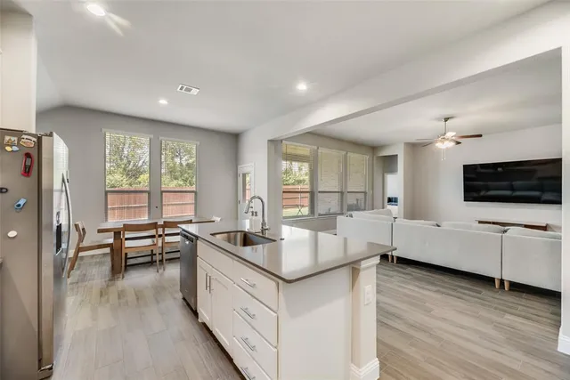 a kitchen with a sink stove and refrigerator