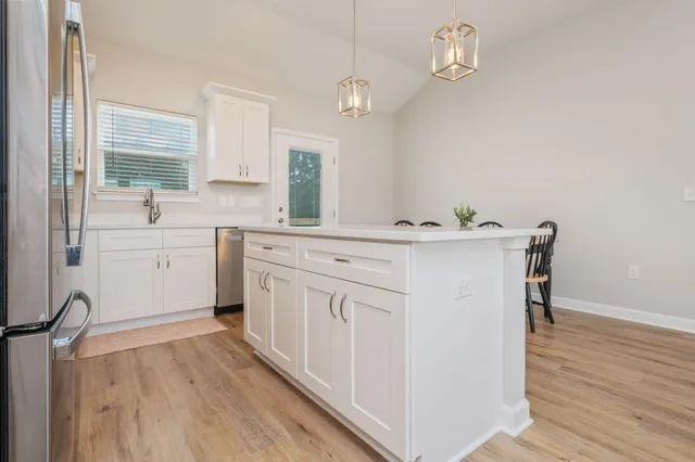 a view of cabinets a wooden floor and a window