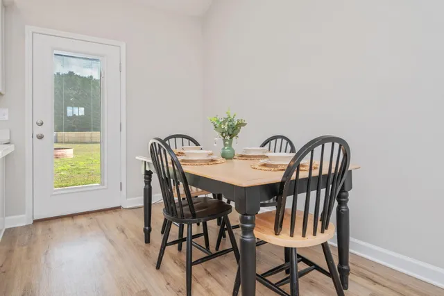 a view of a dining room with furniture and a window