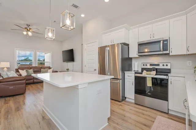 a kitchen with stainless steel appliances a sink stove and refrigerator