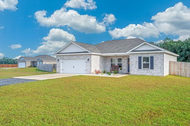 a front view of a house with swimming pool having outdoor seating