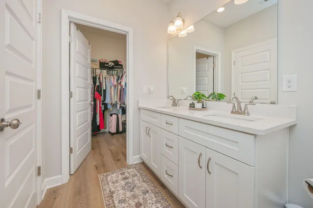 a view of walk in closet with clothes