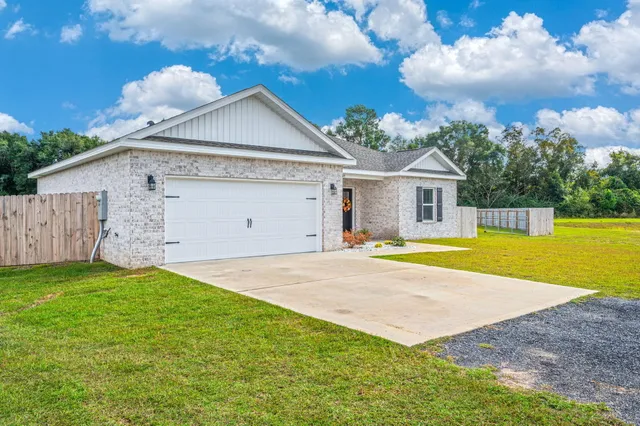 a view of a house with a backyard and a yard