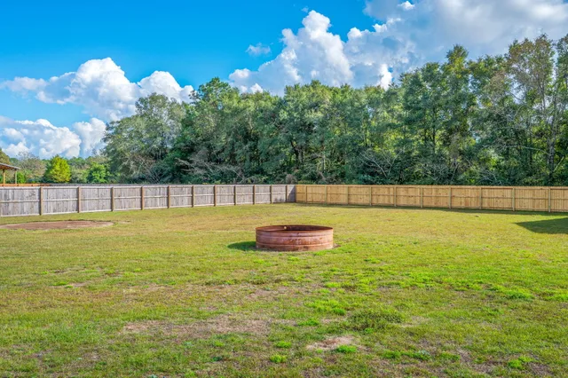 a view of a swimming pool with an outdoor seating and a yard