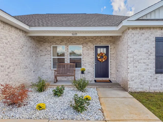 a front view of a house with outdoor seating