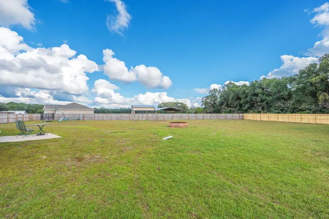 a view of a swimming pool with a yard