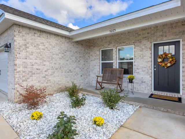 a front view of a house with outdoor seating