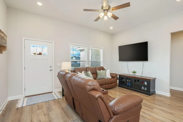 a living room with furniture and a flat screen tv