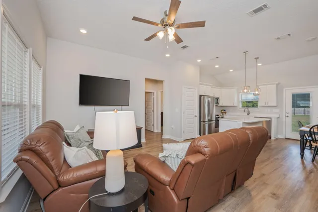 a living room with furniture and a flat screen tv
