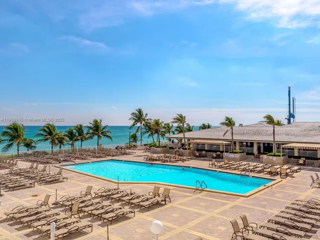 an aerial view of a house with a yard and lake view