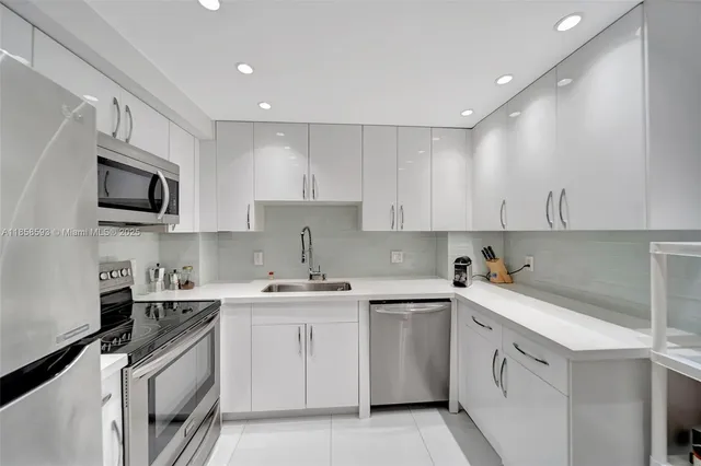 a kitchen with a sink a stove and cabinets