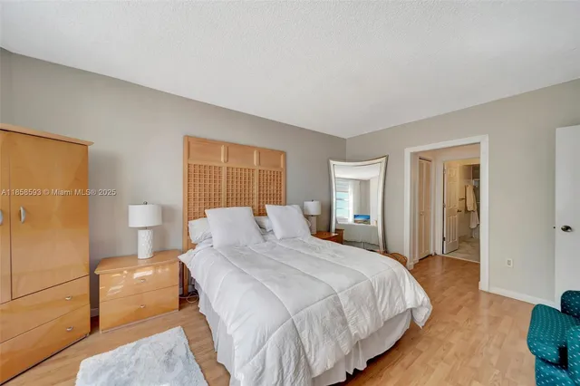 a bedroom with a bed and a lamp