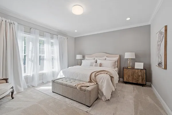 a spacious bedroom with a bed and window