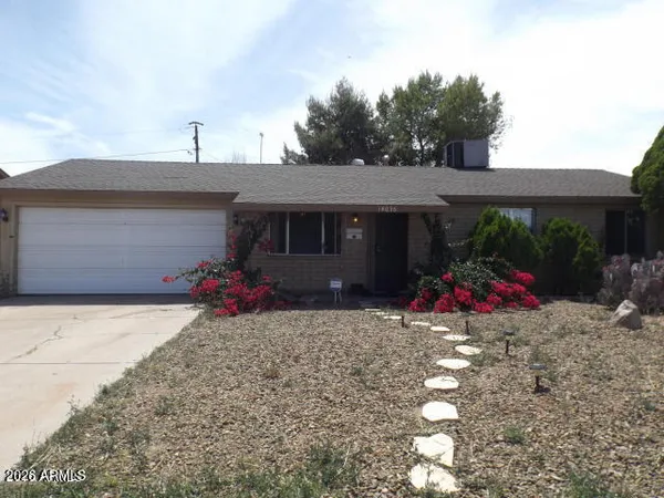 a view of a house with a backyard and a garage