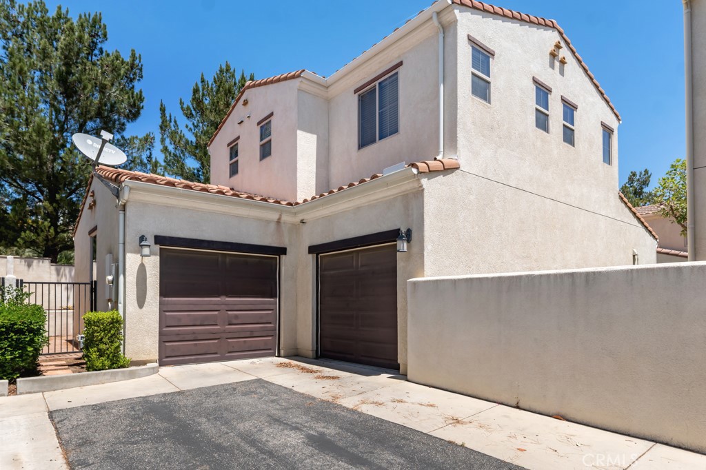 20317 Livorno Porter Ranch Porter Ranch, CA 91326 - Photo 28 of 33 a front view of a house with garage