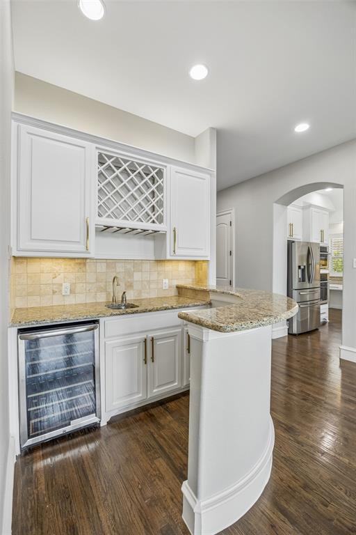 134 Santa Rosa Way Irving, TX 75062 - Photo 4 of 26 Convenient wet bar with wine storage, beverage refrigerator, and ample cabinetry for effortless entertaining.