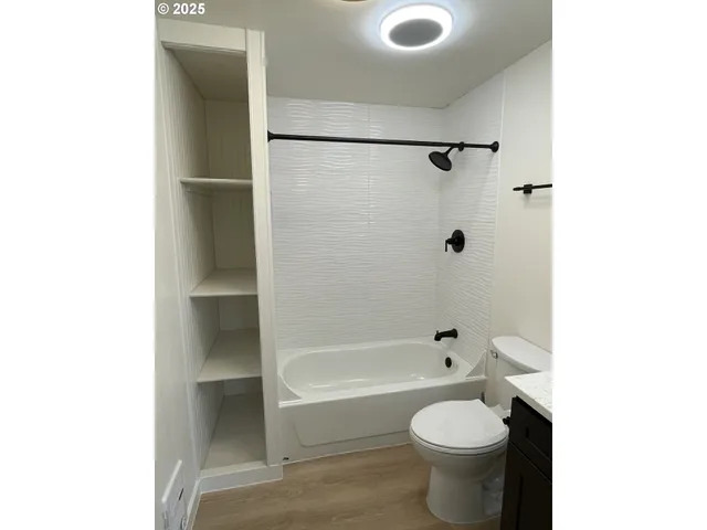 a bathroom with a toilet and a tub