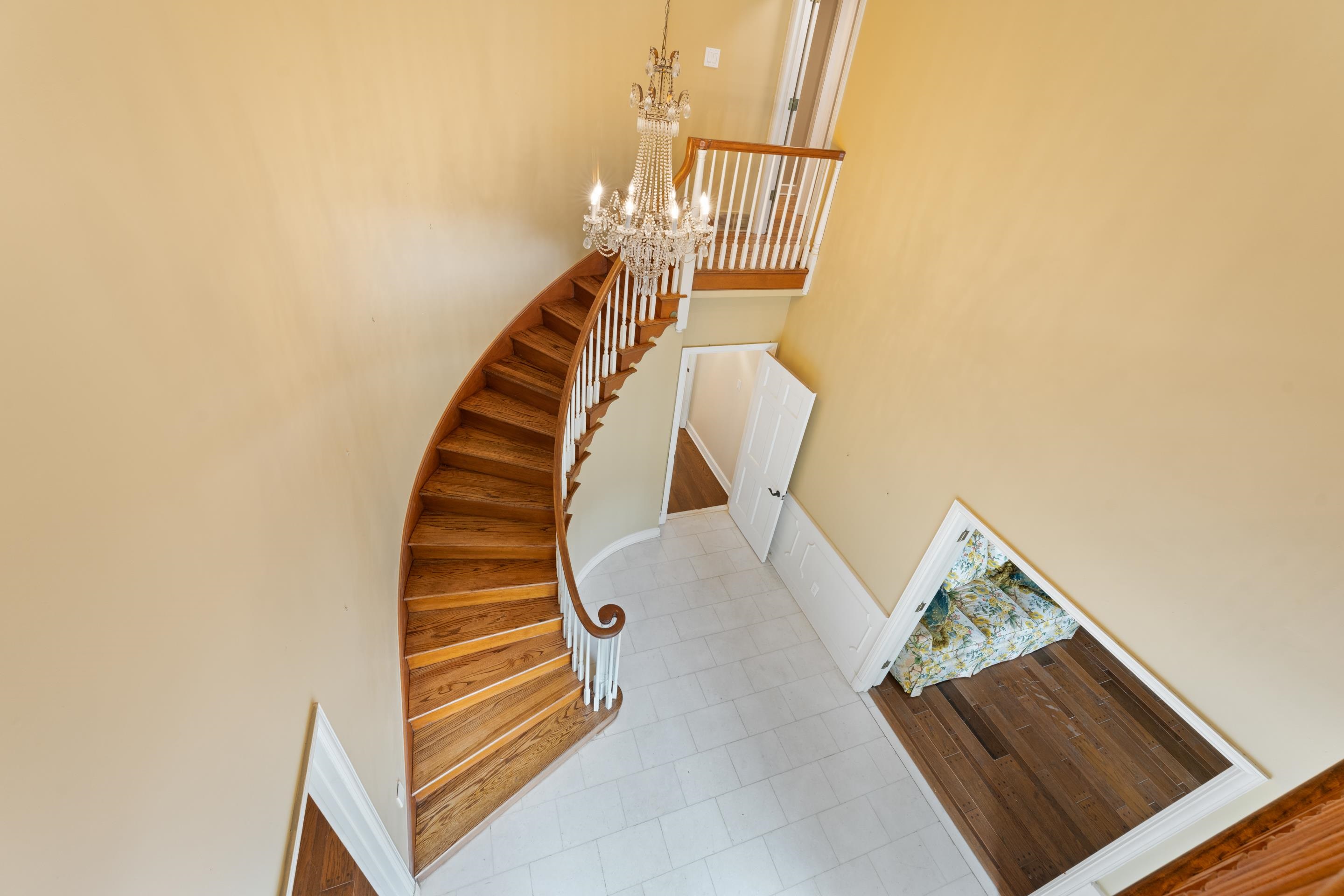 5360 Normandy Road Memphis, TN 38120 - Photo 39 of 40 Stairway with a notable chandelier and marble floors