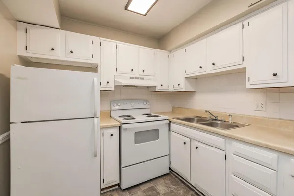 a white refrigerator freezer sitting in a kitchen