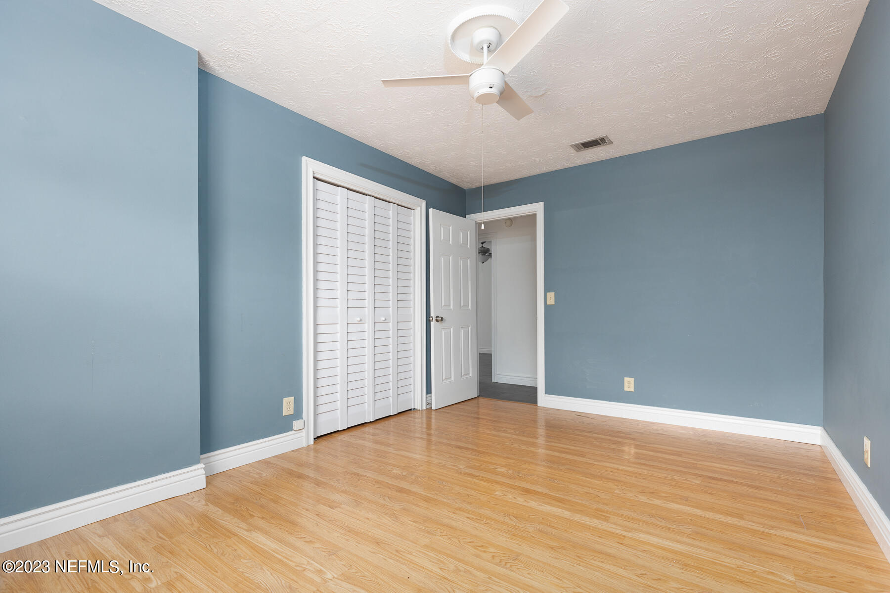 9 Amberjack Road Ponte Vedra Beach, FL 32082 - Photo 13 of 30 a view of an empty room with wooden floor and a window