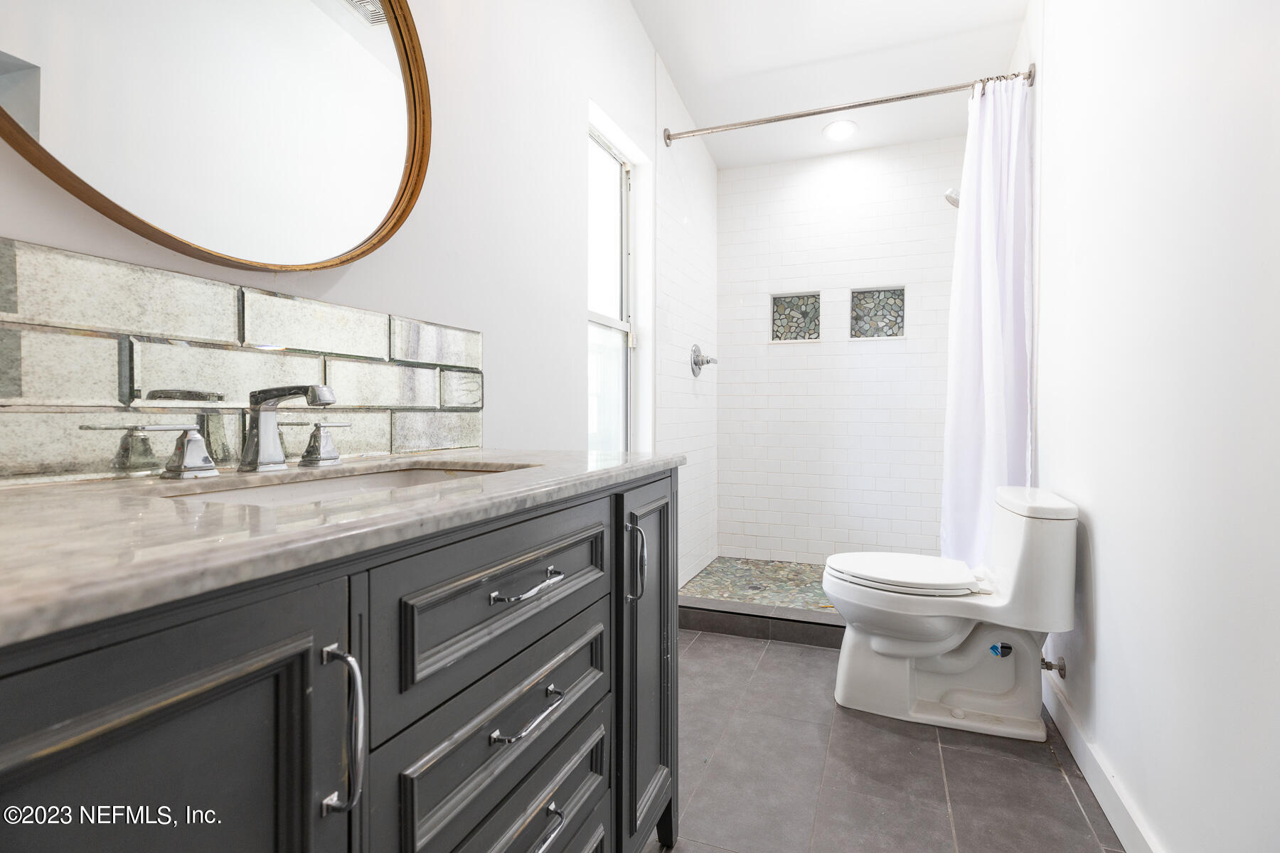 9 Amberjack Road Ponte Vedra Beach, FL 32082 - Photo 20 of 30 a bathroom with a granite countertop sink a toilet and a mirror