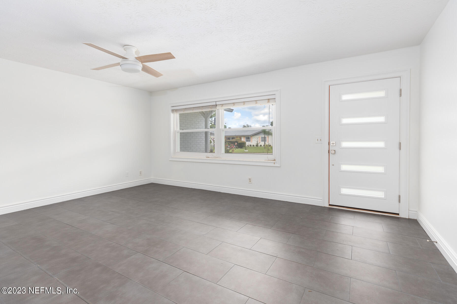 9 Amberjack Road Ponte Vedra Beach, FL 32082 - Photo 3 of 30 a view of an empty room with a window and wooden floor