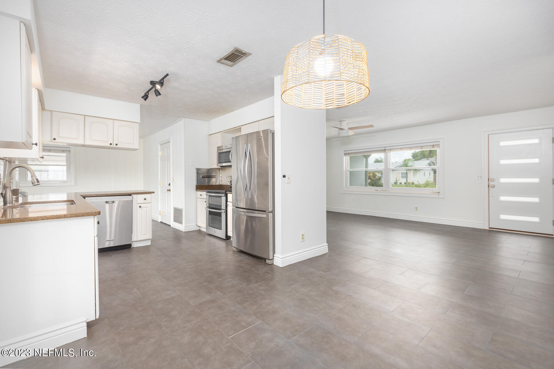 9 Amberjack Road Ponte Vedra Beach, FL 32082 - Photo 5 of 30 a kitchen with stainless steel appliances a refrigerator a sink dishwasher a stove and white cabinets with wooden floor