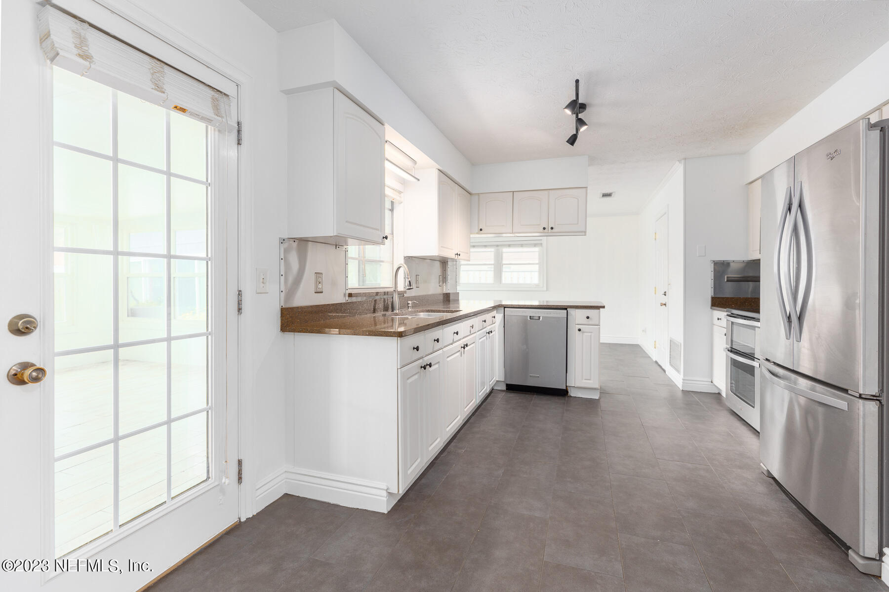 9 Amberjack Road Ponte Vedra Beach, FL 32082 - Photo 6 of 30 a kitchen with white cabinets and white appliances