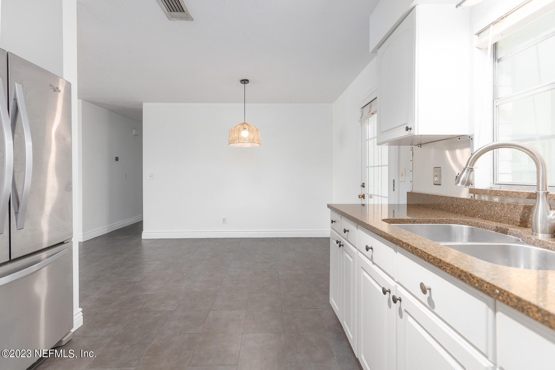9 Amberjack Road Ponte Vedra Beach, FL 32082 - Photo 7 of 30 a kitchen with granite countertop a sink and a refrigerator