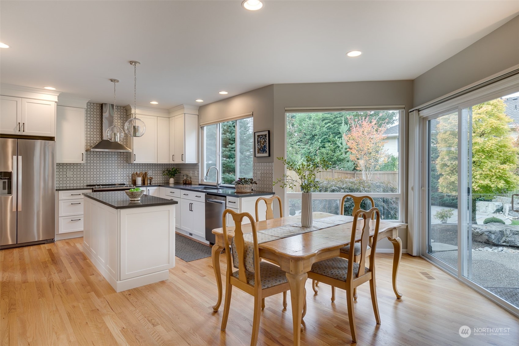 20022 27th Drive Southeast Bothell, WA 98012 - Photo 14 of 37 a kitchen with a table chairs refrigerator and cabinets