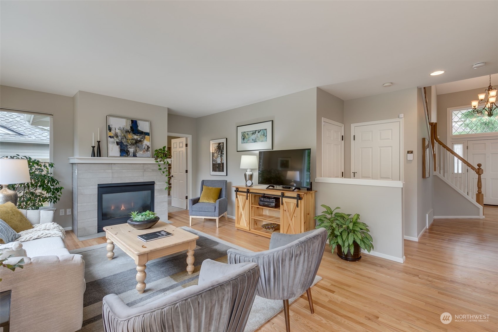 20022 27th Drive Southeast Bothell, WA 98012 - Photo 22 of 37 a living room with furniture a fireplace and a flat screen tv