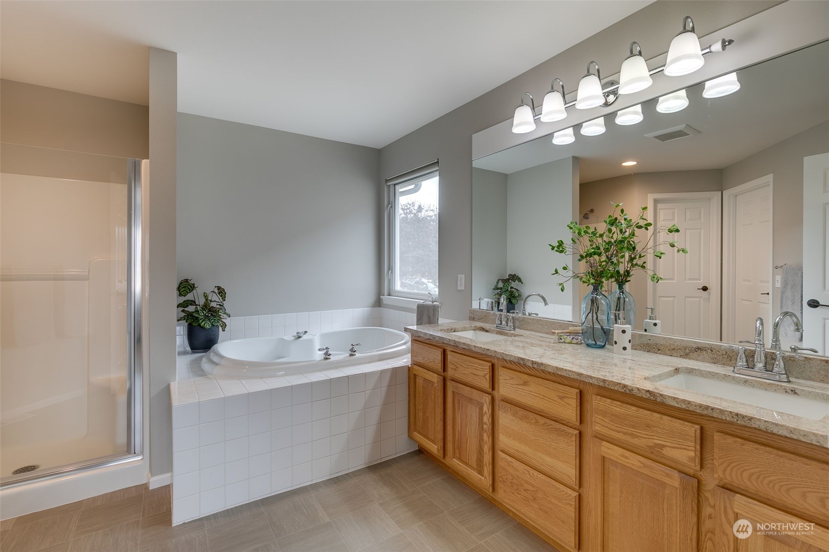 20022 27th Drive Southeast Bothell, WA 98012 - Photo 28 of 37 a bathroom with a sink a faucet a mirror a and a bathtub