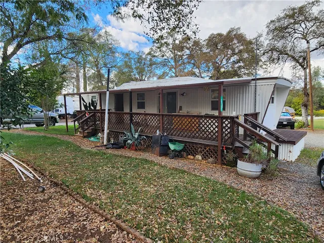 a view of a backyard with sitting area and slide