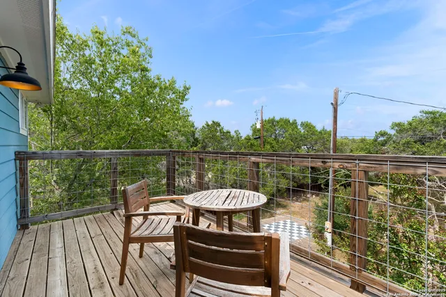 a view of a balcony with two chairs and a table
