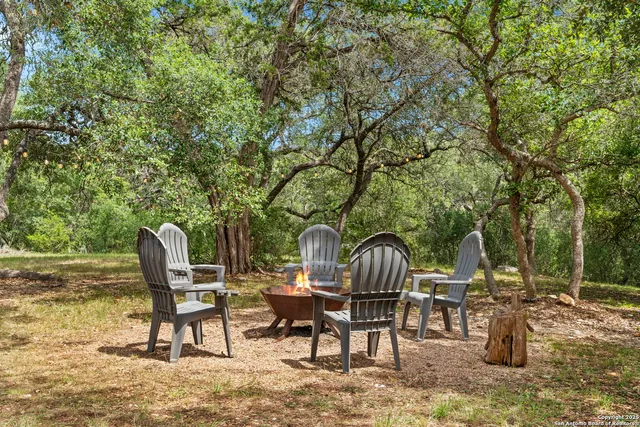 a view of a chairs and table in backyard