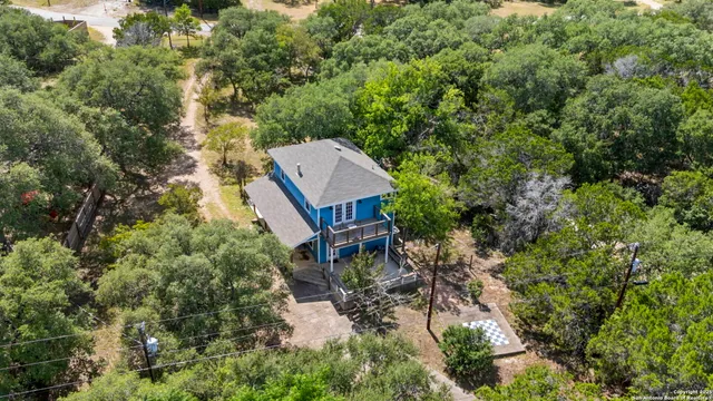an aerial view of a house with a yard
