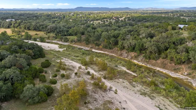 an aerial view of a residential houses with yard
