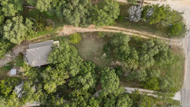 an aerial view of a house with a yard