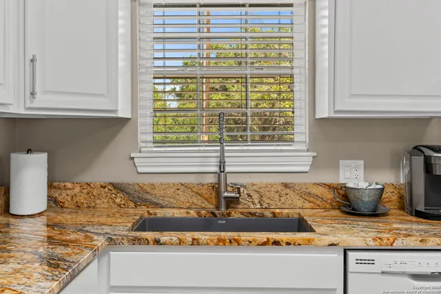 a kitchen with a stove and a window