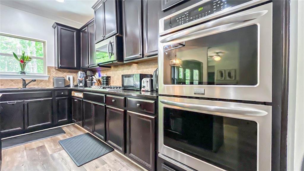3281 Alhambra Circle Hampton, GA 30228 - Photo 27 of 88 a kitchen with stainless steel appliances a stove and a microwave