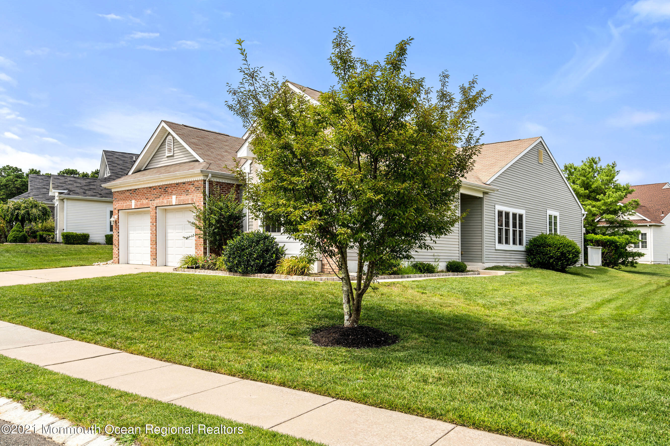 7 Millstone Way Waretown, NJ 08758 - Photo 2 of 45 a front view of a house with a yard