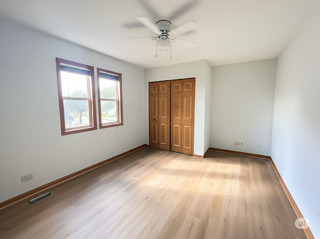416 Fawn Lane Oswego, IL 60543 - Photo 11 of 13 an empty room with windows and ceiling fan