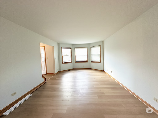 416 Fawn Lane Oswego, IL 60543 - Photo 3 of 13 an empty room with wooden floor and windows