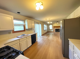 416 Fawn Lane Oswego, IL 60543 - Photo 5 of 13 a kitchen with stainless steel appliances granite countertop a sink a stove and a refrigerator