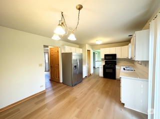 416 Fawn Lane Oswego, IL 60543 - Photo 6 of 13 a view of a kitchen with a sink and an empty room